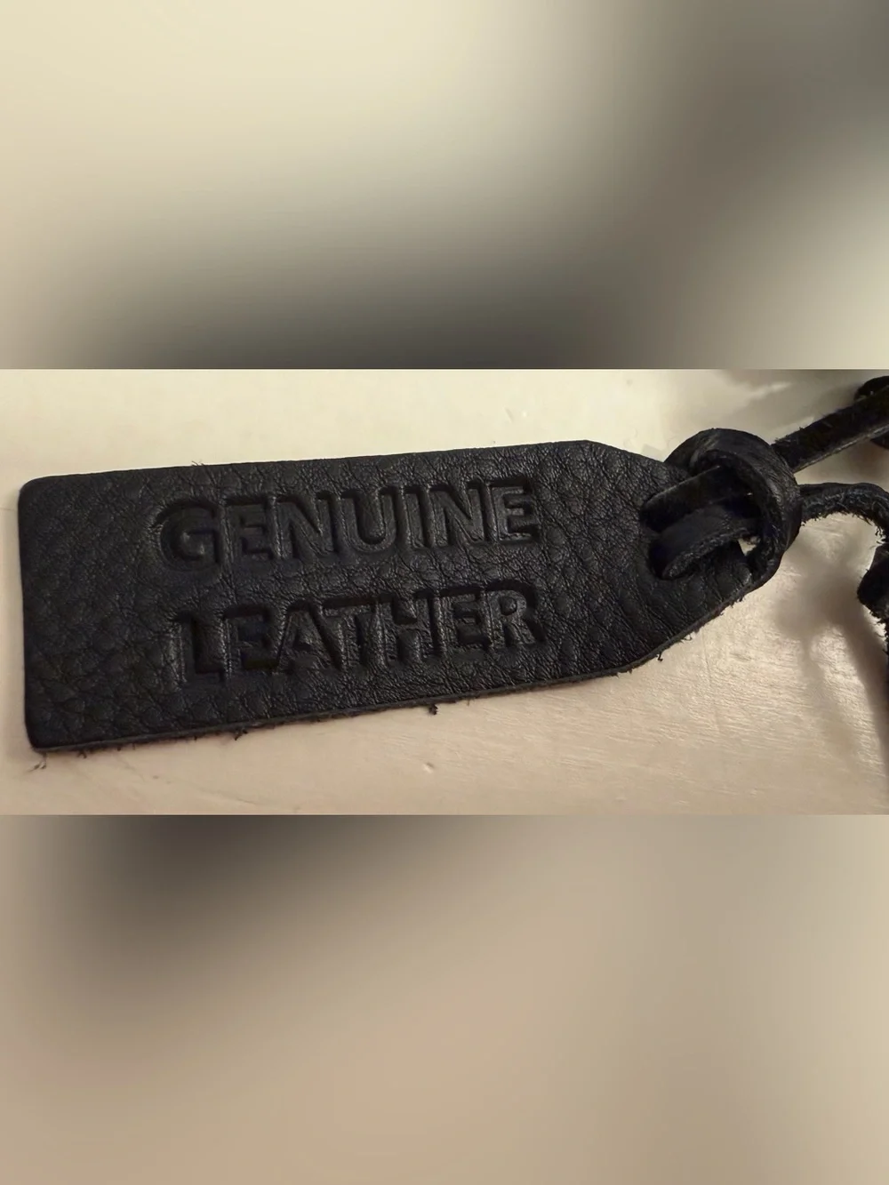 Leather wallet in black with woven flap closure.